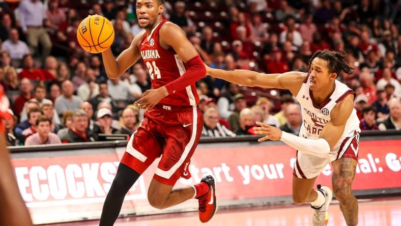 Feb 22, 2023; Columbia, South Carolina, USA; Alabama Crimson Tide forward Brandon Miller (24) drives around South Carolina Gamecocks guard Meechie Johnson (5) in the first half at Colonial Life Arena. Mandatory Credit: Jeff Blake-USA TODAY Sports