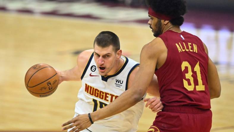 Feb 23, 2023; Cleveland, Ohio, USA; Denver Nuggets center Nikola Jokic (15) fights for position against Cavaliers center Jarrett Allen (31) in the first quarter at Rocket Mortgage FieldHouse. Mandatory Credit: David Richard-USA TODAY Sports