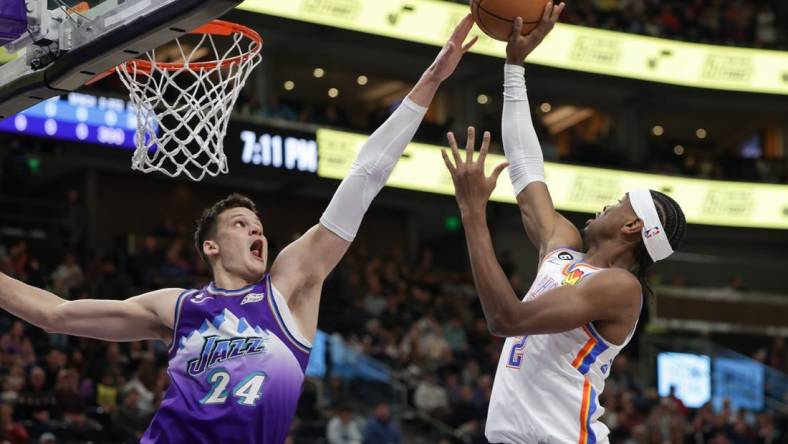 Feb 23, 2023; Salt Lake City, Utah, USA; Utah Jazz center Walker Kessler (24) blocks the shot of Oklahoma City Thunder guard Shai Gilgeous-Alexander (2) during the first quarter at Vivint Arena. Mandatory Credit: Chris Nicoll-USA TODAY Sports