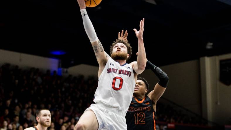 Feb 23, 2023; Moraga, California, USA;  St. Mary's Gaels guard Logan Johnson (0) shoots in front of Pacific Tigers guard Jordan Ivy-Curry (12) during the first half at University Credit Union Pavilion. Mandatory Credit: John Hefti-USA TODAY Sports