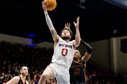 Feb 23, 2023; Moraga, California, USA;  St. Mary's Gaels guard Logan Johnson (0) shoots in front of Pacific Tigers guard Jordan Ivy-Curry (12) during the first half at University Credit Union Pavilion. Mandatory Credit: John Hefti-USA TODAY Sports