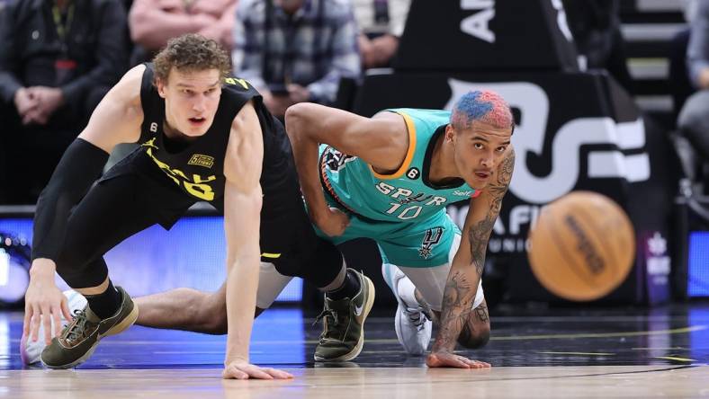 Feb 25, 2023; Salt Lake City, Utah, USA; Utah Jazz forward Lauri Markkanen (23) and San Antonio Spurs forward Jeremy Sochan (10) chase after a loose ball in the second half at Vivint Arena. Mandatory Credit: Rob Gray-USA TODAY Sports