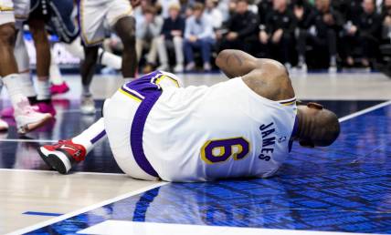 Feb 26, 2023; Dallas, Texas, USA; Los Angeles Lakers forward LeBron James (6) lays on the floor injured during the second half against the Dallas Mavericks at American Airlines Center. Mandatory Credit: Kevin Jairaj-USA TODAY Sports
