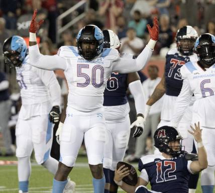 Feb 26, 2023; Houston, TX, USA;  Houston Roughnecks quarterback Brandon Silvers (12) looks for a horse collar call against Arlington  Renegades linebacker Willie Taylor (50) in the third quarter  at TDECU Stadium. Nom penalty was called on the play. Mandatory Credit: Thomas Shea-USA TODAY Sports