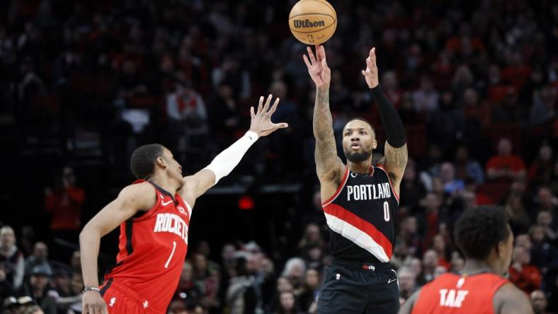 Feb 26, 2023; Portland, Oregon, USA; Portland Trail Blazers point guard Damian Lillard (0) shoots the ball over Houston Rockets power forward Jabari Smith Jr. (1) during the second half at Moda Center. Mandatory Credit: Soobum Im-USA TODAY Sports