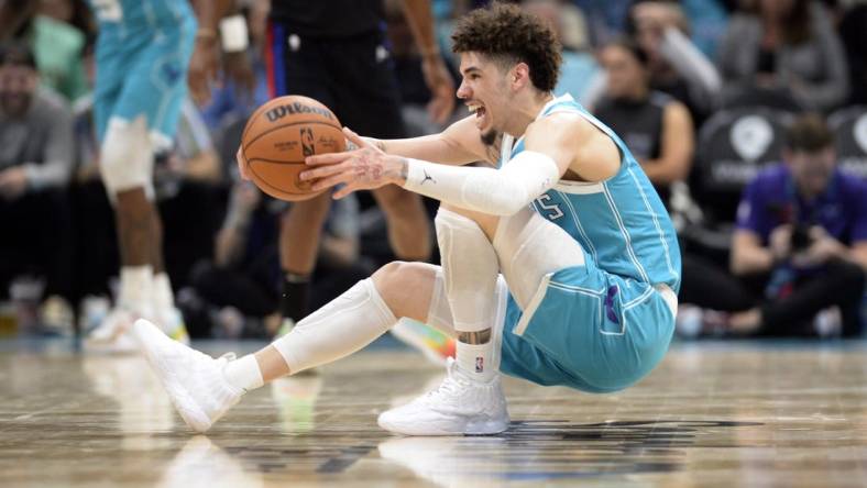 Feb 27, 2023; Charlotte, North Carolina, USA; Charlotte Hornets guard LaMelo Ball (1) controls the ball as he falls down during play during the second half against the Detroit Pistons at the Spectrum Center. Mandatory Credit: Sam Sharpe-USA TODAY Sports