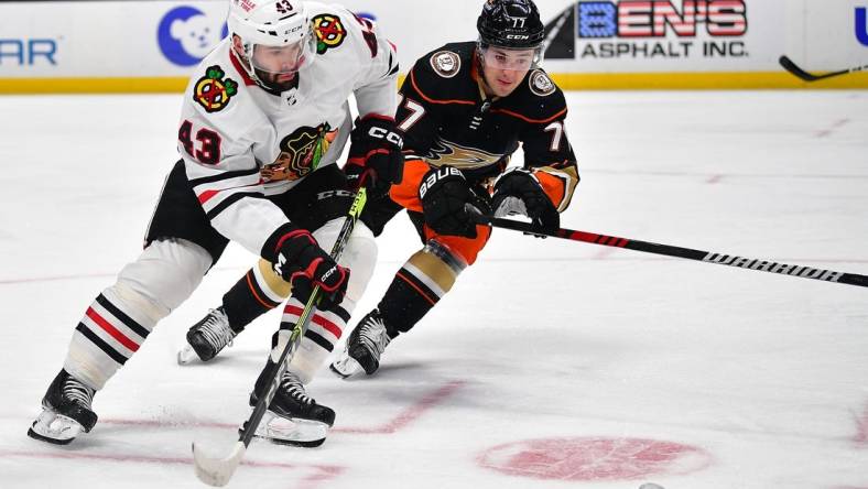 Feb 27, 2023; Anaheim, California, USA; Chicago Blackhawks center Colin Blackwell (43) plays for the puck against Anaheim Ducks right wing Frank Vatrano (77) during the first period at Honda Center. Mandatory Credit: Gary A. Vasquez-USA TODAY Sports