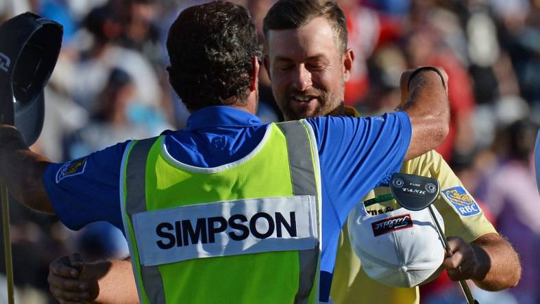 Feb 2, 2020; Scottsdale, Arizona, USA; Webb Simpson hugs his caddie Paul Tesori after winning the Waste Management Phoenix Open golf tournament at TPC Scottsdale. Mandatory Credit: Joe Camporeale-USA TODAY Sports