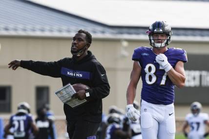 Aug 17, 2020; Owings Mills, Maryland, USA;  Baltimore Ravens tight end coach Bobby Engram  provides direction as tight end Eli Wolf (87) walks across the field at Under Armour Performance Center. Mandatory Credit: Tommy Gilligan-USA TODAY Sports