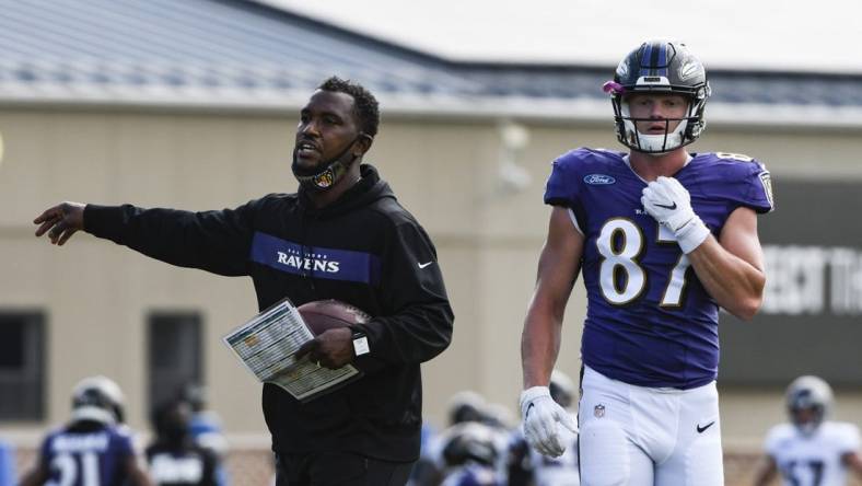 Aug 17, 2020; Owings Mills, Maryland, USA;  Baltimore Ravens tight end coach Bobby Engram  provides direction as tight end Eli Wolf (87) walks across the field at Under Armour Performance Center. Mandatory Credit: Tommy Gilligan-USA TODAY Sports