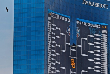 A bird gets an aerial view as the giant March Madness basketball bracket sign begins to come down Tuesday, April 6, 2021 off the J.W. Marriott in downtown Indianapolis, after March Madness and Final Four finished.

With March Madness And Final Four Finished Signage Comes Down