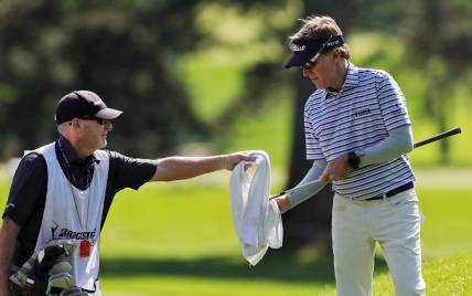Brett Quigley cleans off his club with help from his caddy during the first round of the Bridgestone Senior Players Championship at Firestone Country Club on Thursday, June 24, 2021, in Akron, Ohio.

Bridgestone24 9
