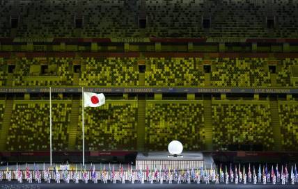Aug 24, 2021; Tokyo, Japan; Athlete's Parade Assistants holding flags of the competing countries in front of the Protocol Stage during the Athlete's Parade at the Opening Ceremony of the Tokyo 2020 Paralympic Games.  Mandatory Credit: Bob Martin/OIS Handout Photo via USA TODAY Sports