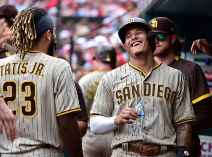 Sep 19, 2021; St. Louis, Missouri, USA;  San Diego Padres third baseman Manny Machado (13) jokes around with center fielder Fernando Tatis Jr. (23) after scoring from first base during the eighth inning against the St. Louis Cardinals at Busch Stadium. Mandatory Credit: Jeff Curry-USA TODAY Sports