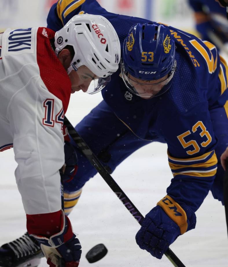 Oct 14, 2021; Buffalo, New York, USA;  Montreal Canadiens center Nick Suzuki (14) and Buffalo Sabres left wing Jeff Skinner (53) take a face-off during the second period at KeyBank Center. Mandatory Credit: Timothy T. Ludwig-USA TODAY Sports