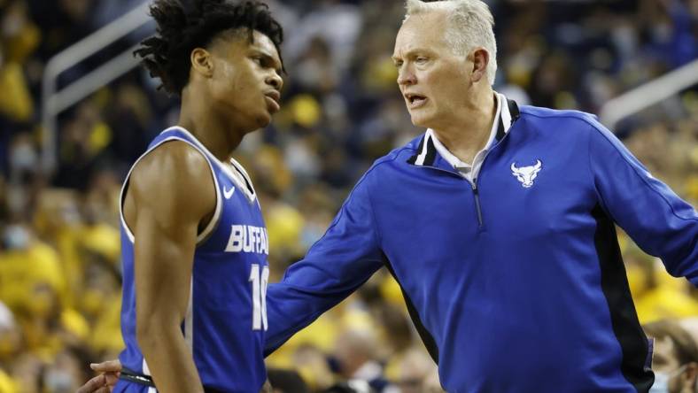 Nov 10, 2021; Ann Arbor, Michigan, USA;  Buffalo Bulls head coach Jim Whitesell greets guard Ronaldo Segu (10) as he comes off the court in the first half against the Michigan Wolverines at Crisler Center. Mandatory Credit: Rick Osentoski-USA TODAY Sports