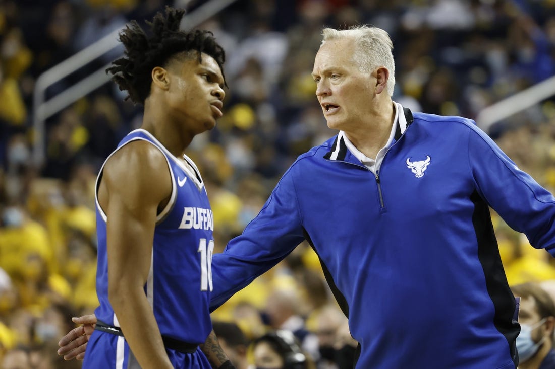 Nov 10, 2021; Ann Arbor, Michigan, USA;  Buffalo Bulls head coach Jim Whitesell greets guard Ronaldo Segu (10) as he comes off the court in the first half against the Michigan Wolverines at Crisler Center. Mandatory Credit: Rick Osentoski-USA TODAY Sports