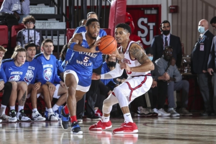 Nov 23, 2021; Queens, New York, USA;  St. Francis Terriers guard Larry Moreno (5) looks to make a pass as he is guarded by St. John   s Red Storm guard Tareq Coburn (10) at Carnesecca Arena. Mandatory Credit: Wendell Cruz-USA TODAY Sports
