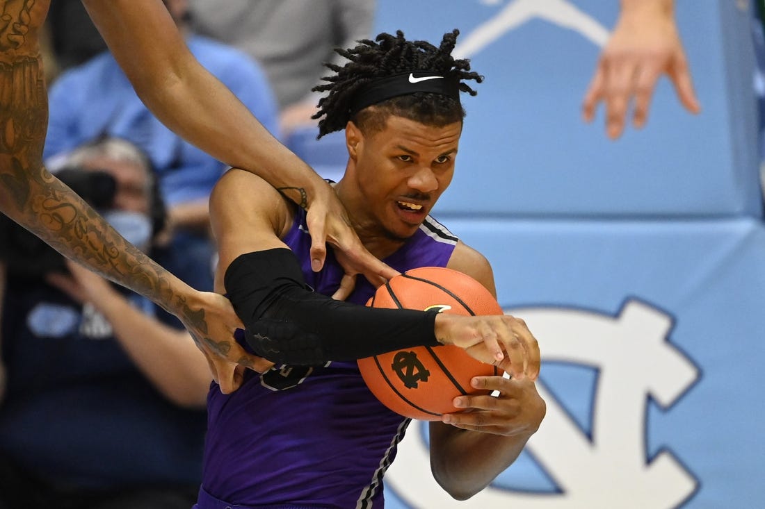 Dec 14, 2021; Chapel Hill, North Carolina, USA;  Furman Paladins guard Mike Bothwell (3) with the ball as North Carolina Tar Heels forward Armando Bacot (5) defends in the second half at Dean E. Smith Center. Mandatory Credit: Bob Donnan-USA TODAY Sports