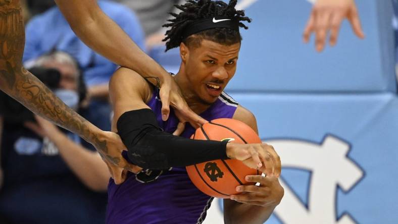 Dec 14, 2021; Chapel Hill, North Carolina, USA;  Furman Paladins guard Mike Bothwell (3) with the ball as North Carolina Tar Heels forward Armando Bacot (5) defends in the second half at Dean E. Smith Center. Mandatory Credit: Bob Donnan-USA TODAY Sports