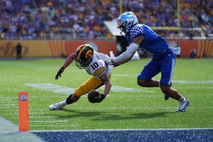 Jan 1, 2022; Orlando, FL, USA; Iowa Hawkeyes wide receiver Arland Bruce IV (10) is unable to make a catch while defended by Kentucky Wildcats safety Vito Tisdale (7) during first half in the 2022 Citrus Bowl at Camping World Stadium. Mandatory Credit: Jasen Vinlove-USA TODAY Sports