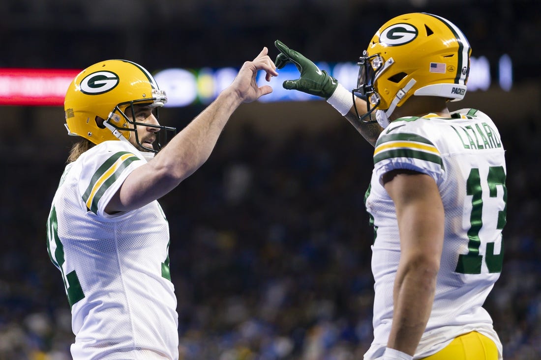 Jan 9, 2022; Detroit, Michigan, USA; Green Bay Packers wide receiver Allen Lazard (13) and quarterback Aaron Rodgers (12) celebrate together after connecting for a touchdown during the second quarter against the Detroit Lions at Ford Field. Mandatory Credit: Raj Mehta-USA TODAY Sports