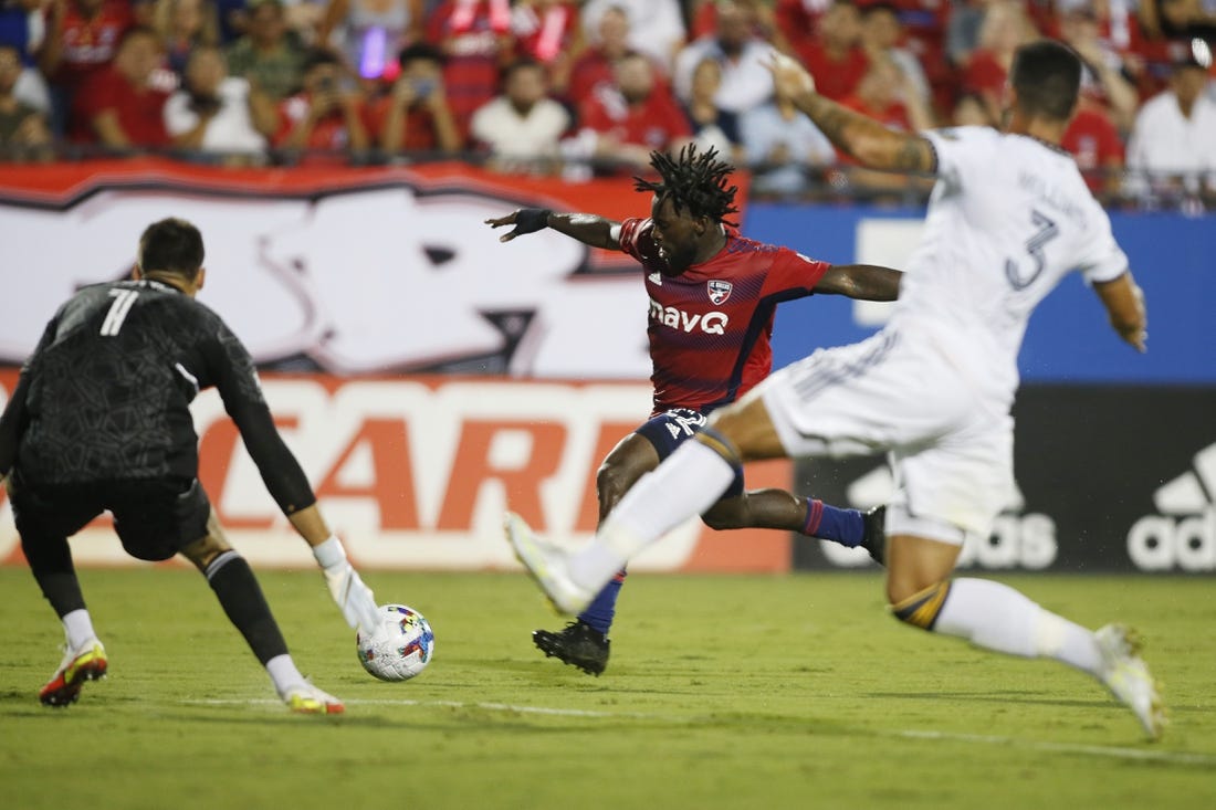 Jul 30, 2022; Frisco, Texas, USA; FC Dallas midfielder Ema Twumasi (22) shoots the ball against Los Angeles Galaxy goalkeeper Jonathan Bond (1) in the second half at Toyota Stadium. Mandatory Credit: Tim Heitman-USA TODAY Sports