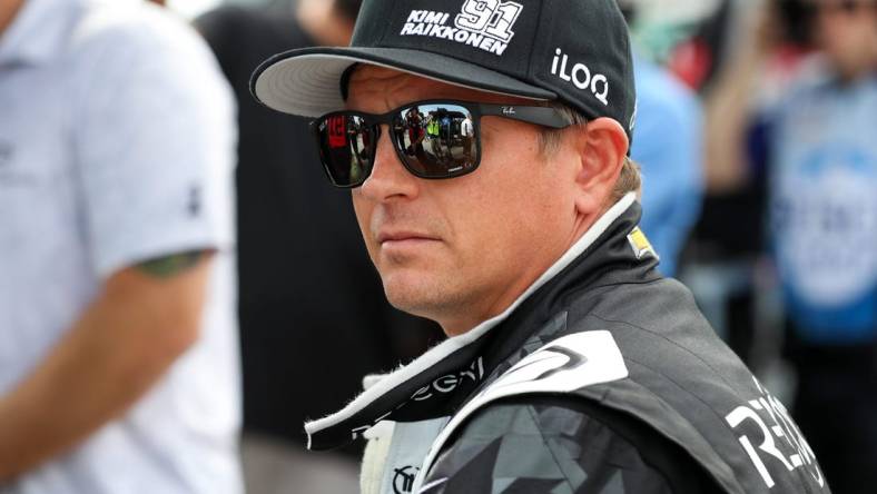 Aug 20, 2022; Watkins Glen, New York, USA; NASCAR Cup Series driver Kimi Raikkonen sits on the pit wall during practice and qualifying for the Go Bowling at The Glen at Watkins Glen International. Mandatory Credit: Matthew OHaren-USA TODAY Sports