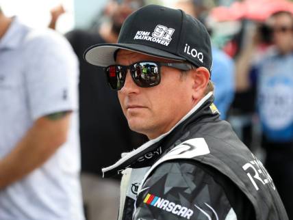 Aug 20, 2022; Watkins Glen, New York, USA; NASCAR Cup Series driver Kimi Raikkonen sits on the pit wall during practice and qualifying for the Go Bowling at The Glen at Watkins Glen International. Mandatory Credit: Matthew OHaren-USA TODAY Sports