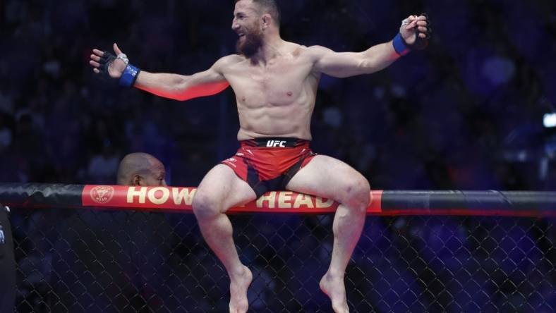 Aug 20, 2022; Salt Lake City, Utah, USA; Merab Dvalishvili (blue gloves) reacts after defeating Jose Aldo (red gloves) during UFC 278 at Vivint Arena. Mandatory Credit: Jeffrey Swinger-USA TODAY Sports