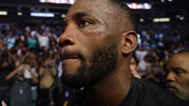 Aug 20, 2022; Salt Lake City, Utah, USA; Leon Edwards (blue gloves) leaves the arena after defeating Kamaru Usman (red gloves) during UFC 278 at Vivint Arena. Mandatory Credit: Jeffrey Swinger-USA TODAY Sports