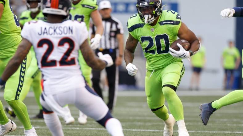 Sep 12, 2022; Seattle, Washington, USA; Seattle Seahawks running back Rashaad Penny (20) rushes against the Denver Broncos during the first quarter at Lumen Field. Mandatory Credit: Joe Nicholson-USA TODAY Sports