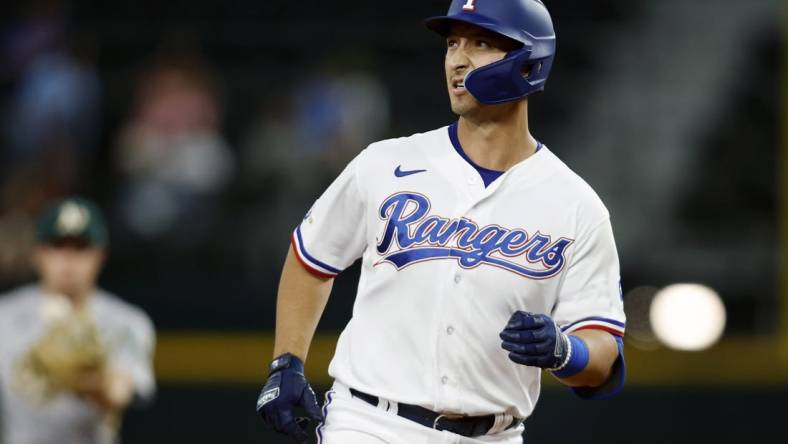 Sep 13, 2022; Arlington, Texas, USA; Texas Rangers first baseman Mark Mathias (9) rounds the bases after hitting a two run home run in the seventh inning against the Oakland Athletics at Globe Life Field. Mandatory Credit: Tim Heitman-USA TODAY Sports