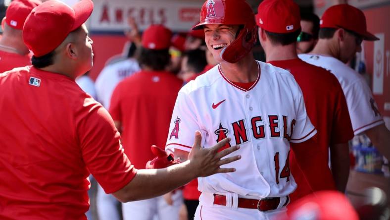 Oct 2, 2022; Anaheim, California, USA;  Los Angeles Angels catcher Logan O'Hoppe (14) is greeted in the dugout after scoring a run during the first inning at Angel Stadium. Mandatory Credit: Kiyoshi Mio-USA TODAY Sports