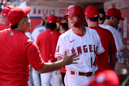 Oct 2, 2022; Anaheim, California, USA;  Los Angeles Angels catcher Logan O'Hoppe (14) is greeted in the dugout after scoring a run during the first inning at Angel Stadium. Mandatory Credit: Kiyoshi Mio-USA TODAY Sports