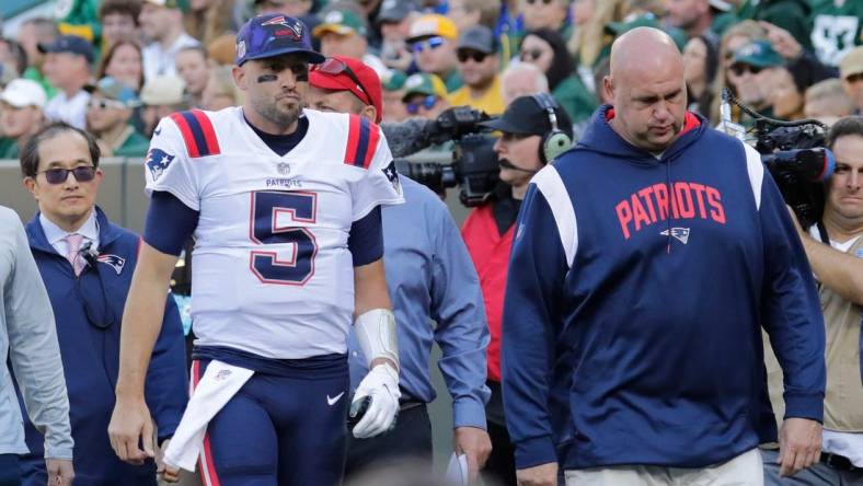 New England Patriots quarterback Brian Hoyer (5) leaves the field in the second quarter against the Green Bay Packers on Sunday, Oct. 2, at Lambeau Field in Green Bay, Wisconsin. He was being evaluated for a head injury.

Mjs Apc Packvspatriots 1002220574djp