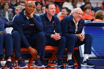 Oct 14, 2022; Syracuse, New York, US; Syracuse Orange associate head coach Adrian Autry (left) and assistant coach Gerry McNamara (center) and head coach Jim Boeheim (right) watch the action at the Orange Tip Off at the JMA Wireless Dome. Mandatory Credit: Rich Barnes-USA TODAY Sports