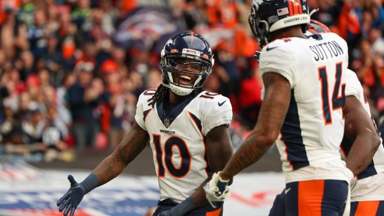 Oct 30, 2022; London, United Kingdom, Denver Broncos wide receiver Jerry Jeudy (10) is congratulated by wide receiver Courtland Sutton (14) after scoring a touchdown against the Jacksonville Jaguars in the second quarter during an NFL International Series game at Wembley Stadium. Mandatory Credit: Nathan Ray Seebeck-USA TODAY Sports