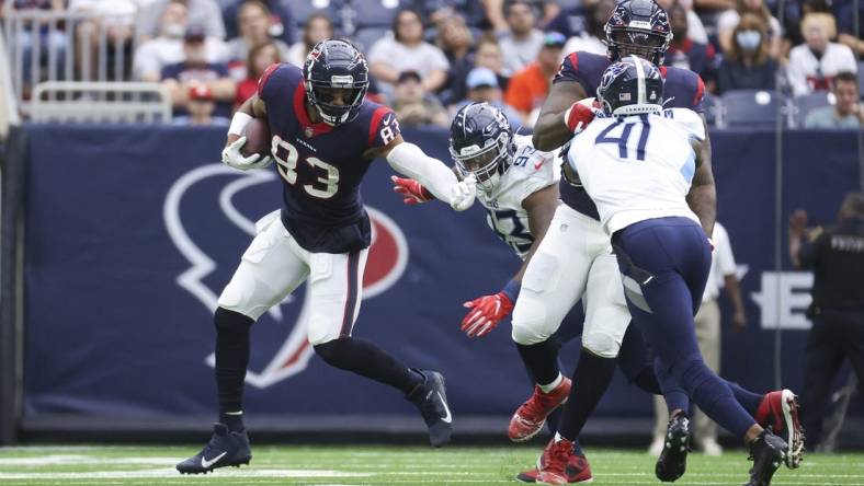 Oct 30, 2022; Houston, Texas, USA; Houston Texans tight end O.J. Howard (83) runs with the ball as Tennessee Titans defensive tackle Teair Tart (93) attempts to make a tackle during the first quarter at NRG Stadium. Mandatory Credit: Troy Taormina-USA TODAY Sports