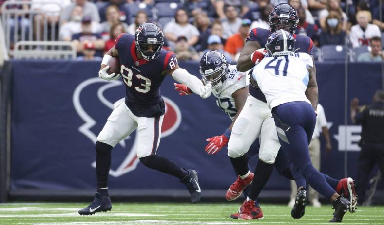 Oct 30, 2022; Houston, Texas, USA; Houston Texans tight end O.J. Howard (83) runs with the ball as Tennessee Titans defensive tackle Teair Tart (93) attempts to make a tackle during the first quarter at NRG Stadium. Mandatory Credit: Troy Taormina-USA TODAY Sports