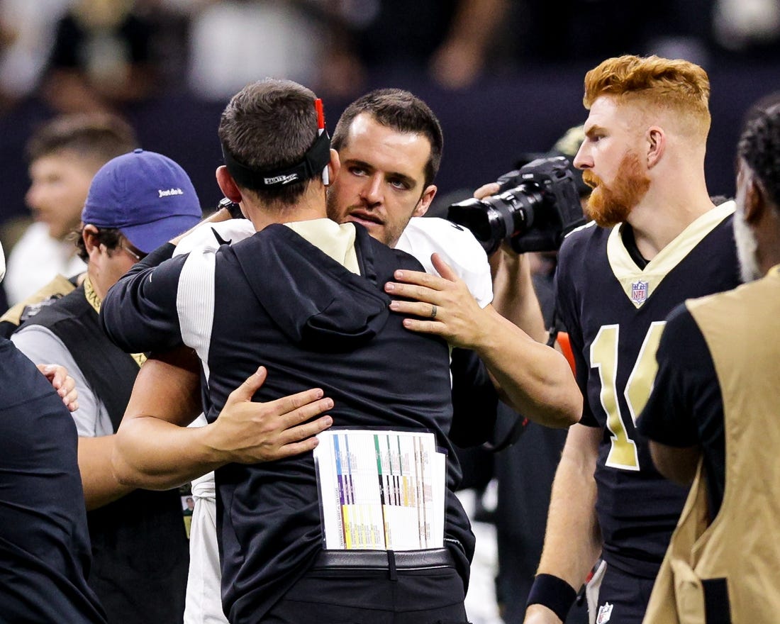 Oct 30, 2022; New Orleans, Louisiana, USA;  New Orleans Saints head coach Dennis Allen hugs Las Vegas Raiders quarterback Derek Carr (4) after the game at Caesars Superdome. Mandatory Credit: Stephen Lew-USA TODAY Sports