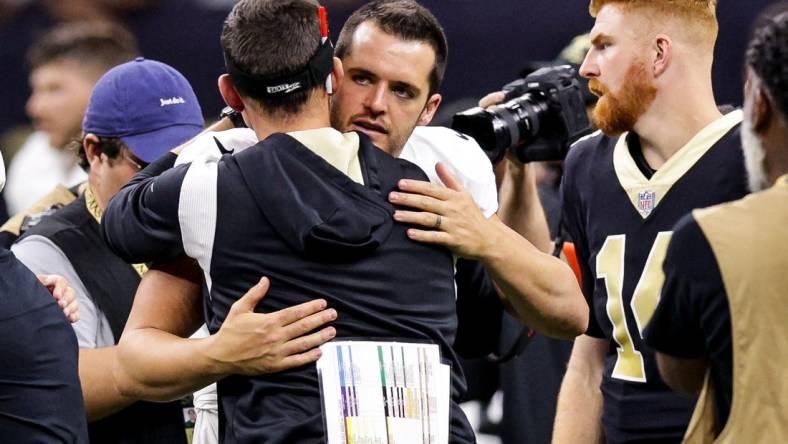 Oct 30, 2022; New Orleans, Louisiana, USA;  New Orleans Saints head coach Dennis Allen hugs Las Vegas Raiders quarterback Derek Carr (4) after the game at Caesars Superdome. Mandatory Credit: Stephen Lew-USA TODAY Sports