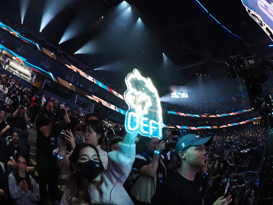 Nov 5, 2022; San Francisco, California, USA; A fan holds a sign for DRX bot laner Kim "Deft" Hyuk-kyu (not pictured) after winning the League of Legends World Championships against T1 at Chase Center. Mandatory Credit: Kelley L Cox-USA TODAY Sports