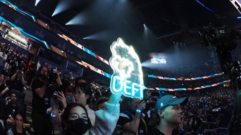 Nov 5, 2022; San Francisco, California, USA; A fan holds a sign for DRX bot laner Kim "Deft" Hyuk-kyu (not pictured) after winning the League of Legends World Championships against T1 at Chase Center. Mandatory Credit: Kelley L Cox-USA TODAY Sports