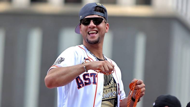 Nov 7, 2022; Houston, Texas, USA; Houston Astros first baseman Yuli Gurriel (10) throws beads to the crowd atop a parade vehicle during the Houston Astros Championship Parade in Houston, TX. Mandatory Credit: Erik Williams-USA TODAY Sports