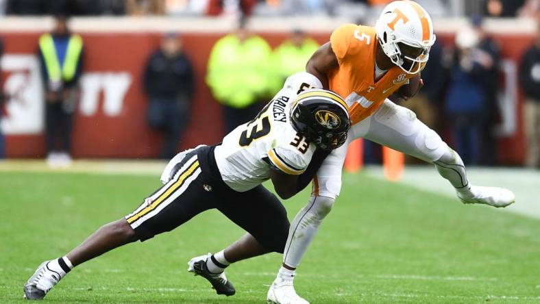 ***DUP***Tennessee quarterback Hendon Hooker (5)/Tennessee defensive back Kamal Hadden(5) is pulled down by Missouri linebacker Chad Bailey (33) during the NCAA college football game on Saturday, November 12, 2022 in Knoxville, Tenn.

Ut Vs Missouri