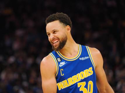 Nov 14, 2022; San Francisco, California, USA; Golden State Warriors point guard Stephen Curry (30) smiles between plays against the San Antonio Spurs during the second quarter at Chase Center. Mandatory Credit: Kelley L Cox-USA TODAY Sports