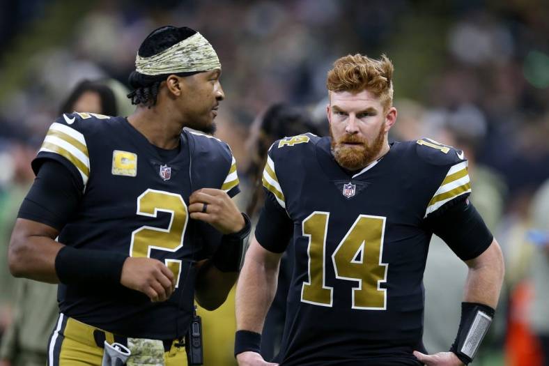 Nov 20, 2022; New Orleans, Louisiana, USA; New Orleans Saints quarterbacks Jameis Winston (2) and Andy Dalton (14) talk in the second half against the New Orleans Saints at the Caesars Superdome. Mandatory Credit: Chuck Cook-USA TODAY Sports