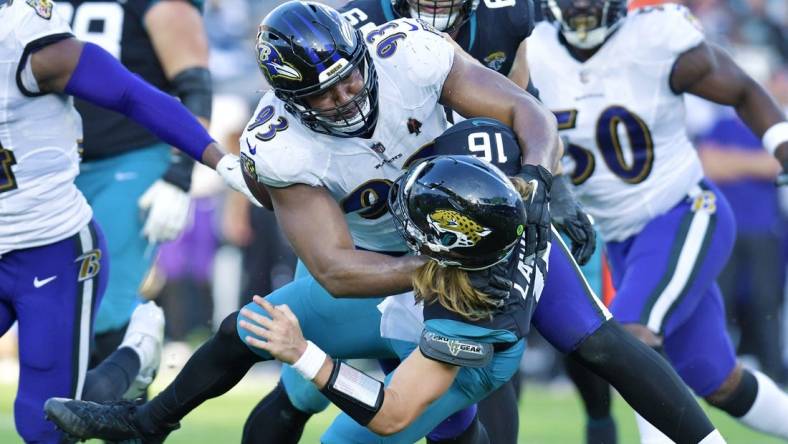 Baltimore Ravens defensive tackle Calais Campbell (93) takes Jacksonville Jaguars quarterback Trevor Lawrence (16) to the turf with under two minutes to play in the game. The Jacksonville Jaguars hosted the Baltimore Ravens at TIAA Bank Field in Jacksonville, FL Sunday, November 27, 2022. The Jaguars got momentum late in the game to win 28 to 27 over the Ravens. [Bob Self/Florida Times-Union]

Jki 112722 Bs Jaguars Vs R 18