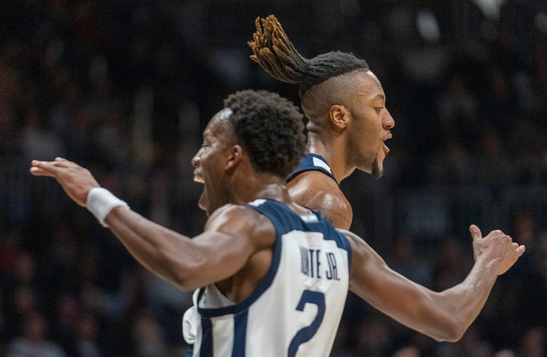 Butler Bulldogs guard Eric Hunter Jr. (2) and teammate Manny Bates (15) celebrate at Hinkle Fieldhouse, Wednesday, Nov. 30, 2022, during Butler   s 76-64 win over Kansas State.